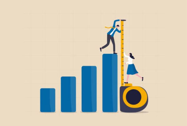 graphic of a cartoon businessman walking across a chart going up, and a cartoon businesswoman standing on a measuring tape