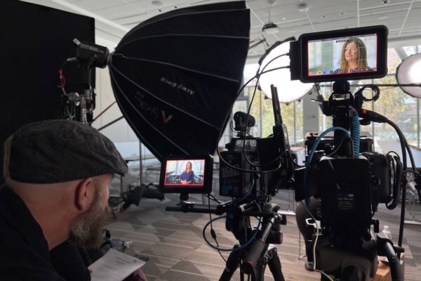Employee speaking on camera in professional lighting setup
